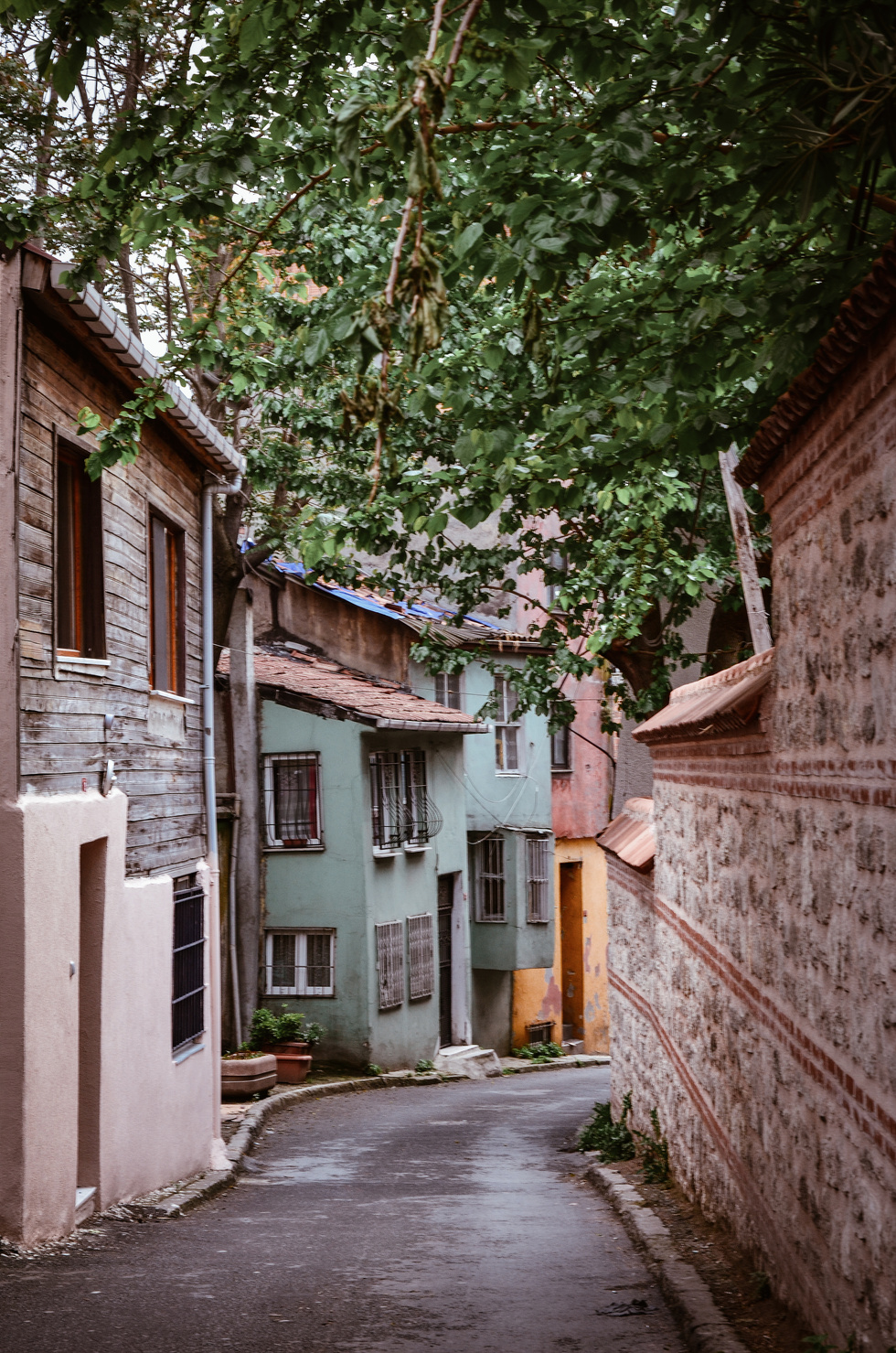 Concrete Road Between Wall And Houses